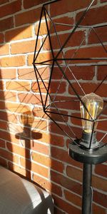 Close-up of lamp against wall