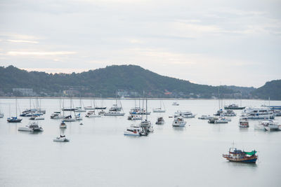 Boats moored in sea against sky