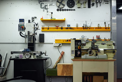 Bright interior of modern spacious repair workshop with various metal instruments and appliances