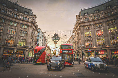 Vehicles on road against buildings in city