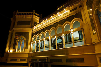 Low angle view of illuminated building at night