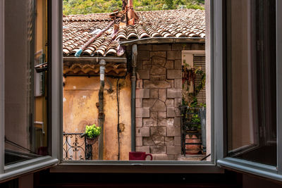 A red cup of coffee on window sill of building