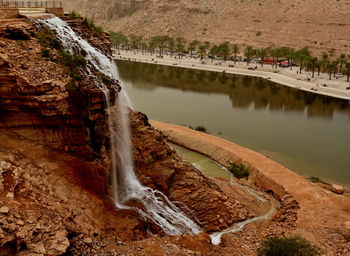 High angle view of waterfall by river