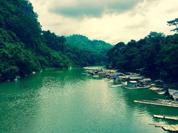 Boats in river with mountain in background