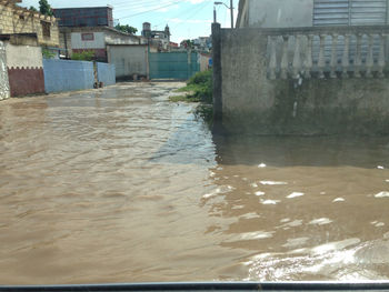 River flowing amidst buildings against sky