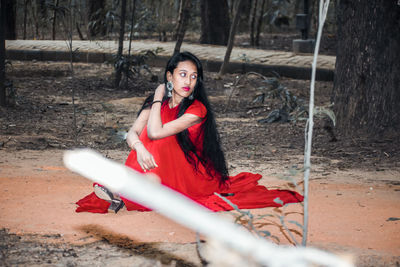 Portrait of woman sitting on field