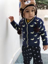 Portrait of cute boy standing outdoors