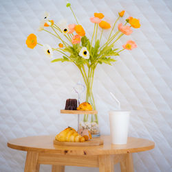 Flowers in vase on table at home