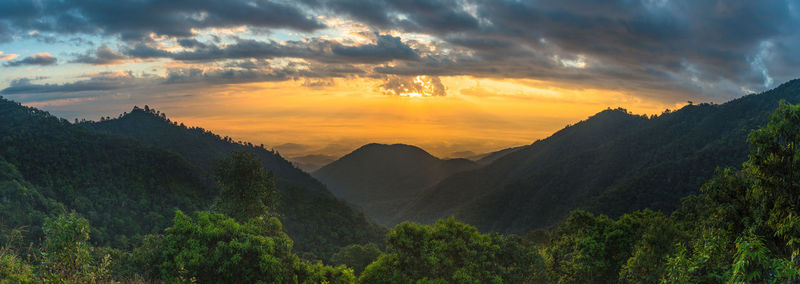 Scenic view of mountains against cloudy sky