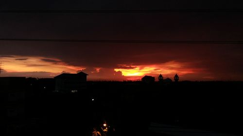 Silhouette of built structure against dramatic sky