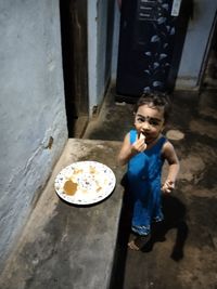 High angle view of girl holding food