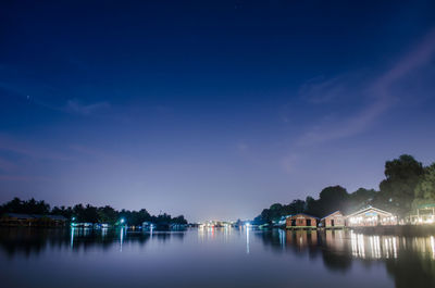 Scenic view of lake against sky at night