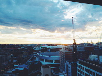 High angle view of buildings against cloudy sky