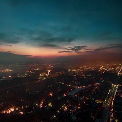 High angle view of illuminated buildings against sky during sunset
