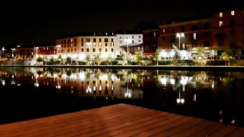 Reflection of illuminated buildings in lake at night