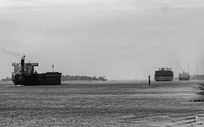 Commercial dock by sea against sky