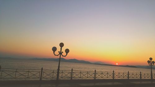 Scenic view of sea against clear sky during sunset