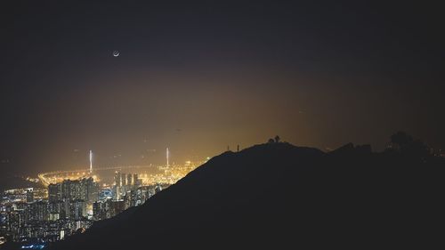 Panoramic view of silhouette moon against sky at night