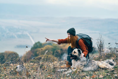 Dog on land against sky