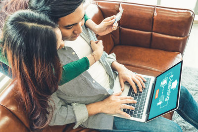 Rear view of woman using mobile phone