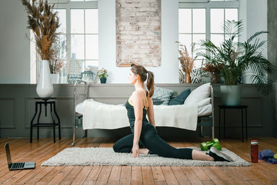 Woman sitting on sofa at home