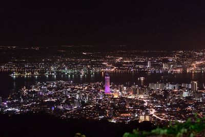 High angle view of city lit up at night