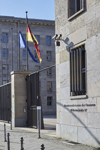 Low angle view of flag against buildings in city