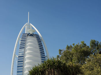 Low angle view of modern building against clear blue sky