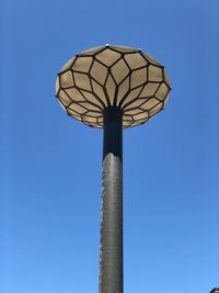 Low angle view of street light against blue sky