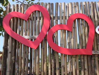 Low angle view of heart shape on bamboo wall