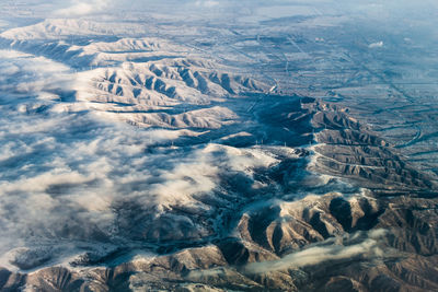 Aerial view of mountain range during foggy weather