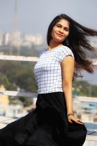 Portrait of a beautiful young woman standing outdoors