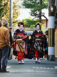 Full length of woman standing on tree trunk