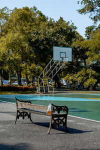 Empty chairs by swimming pool in park