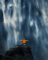 Standing in front of the beautiful waterfall