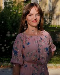 Portrait of a smiling young woman standing outdoors