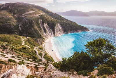 High angle view of sea and mountains against sky