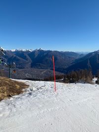 Scenic view of snowcapped mountains against clear blue sky