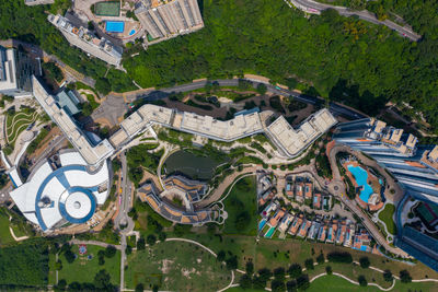 High angle view of swimming pool by buildings in city