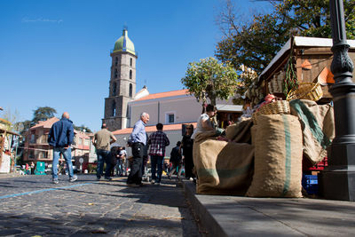 People at town square against clear sky