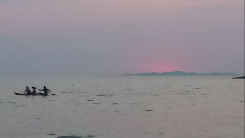 People on beach against sky