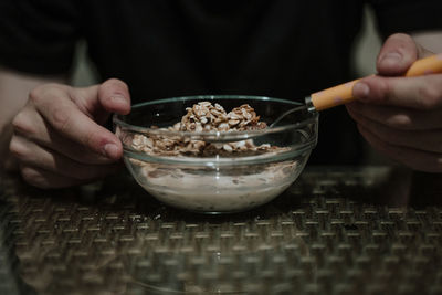 Midsection of man holding ice cream in bowl