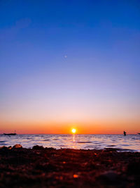 Scenic view of sea against clear sky during sunset