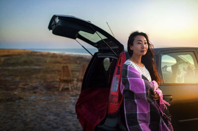 Portrait of young woman in car