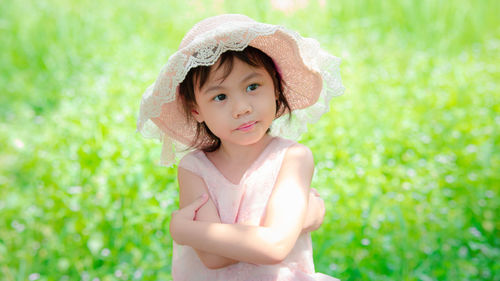 Portrait of young woman standing against plants