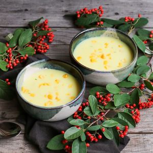 Soup by leaves in bowls on table