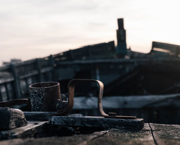 Close-up of old abandoned building against sky