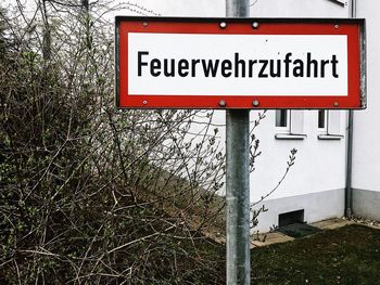 Close-up of information sign against trees
