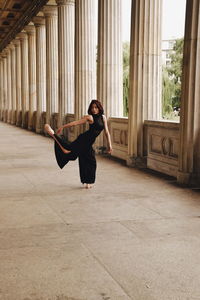 Full length of young woman dancing on floor