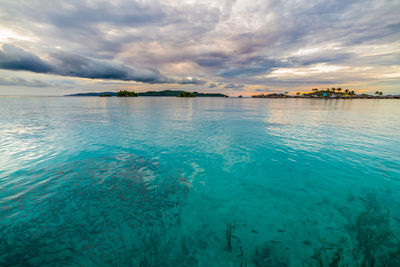 Scenic view of sea against cloudy sky